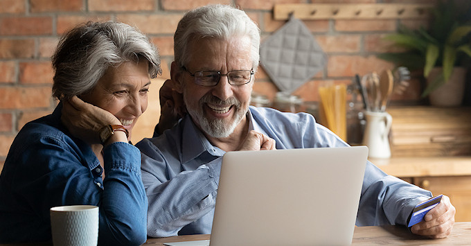 Mature couple shopping for home insurance online